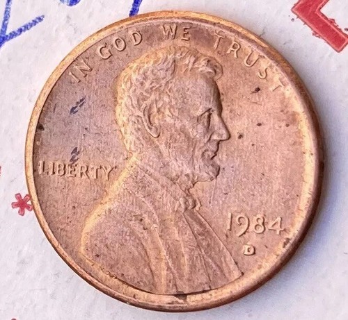 1984 off-center strike penny showing Lincoln's portrait shifted toward one edge with a blank crescent on the opposite side